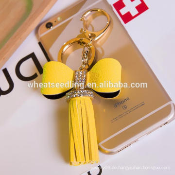 Jinhua neue Art niedrige moq Bowknot-Troddel kundenspezifisches ledernes keychain